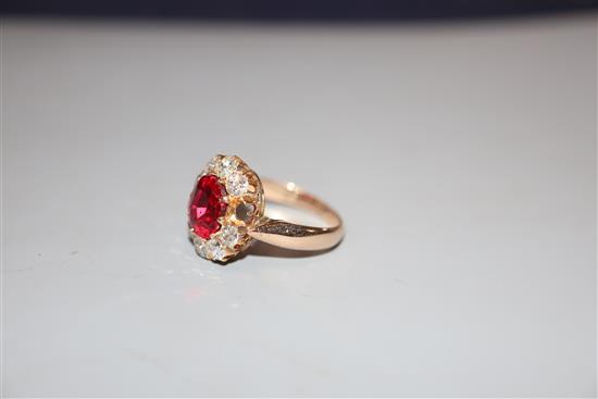 An early-mid 20th century yellow metal, red doublet and diamond set oval cluster ring, size K, gross 4.4 grams.